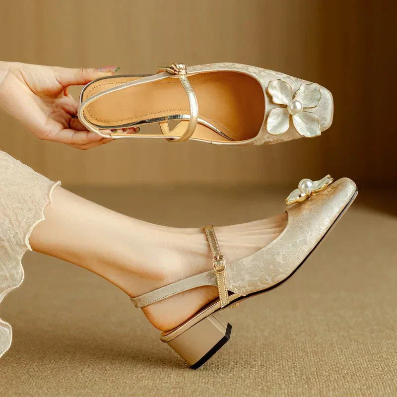 Beige suede Mary Jane pumps with pearl flower detail — top and worn view